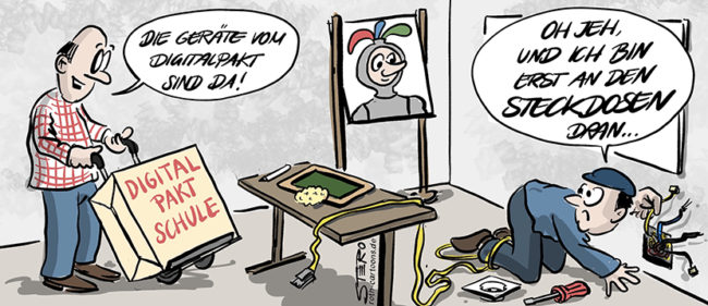 Comic-Cartooon-Bild zum Digitalpakt Schule. Ein Mann bringt das Paket mit digitalen Geräten und Tablets auf einer Sackkarre in ein Klassenzimmer. Der andere sagt verzweifelt: Oh jeh, ich hab noch nicht mal die Steckdosen fertig.
